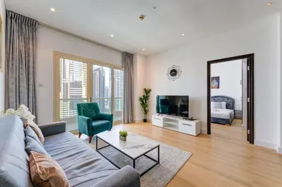 a living room with a couch and a tv at Royal Oceanic - Bright Two Bed on the 14th Floor in Dubai