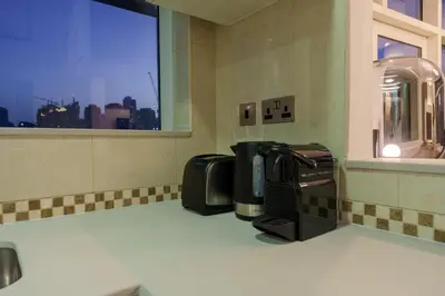 a coffee machine sitting on a counter in a bathroom at Exquisite 2-Bedroom with Panoramic Marina view in Dubai