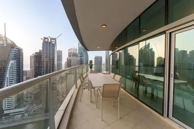 a balcony with a table and chairs on a building at Exquisite 2-Bedroom with Panoramic Marina view in Dubai