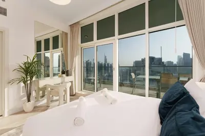 a bedroom with a white bed and a large window at Exquisite 2-Bedroom with Panoramic Marina view in Dubai