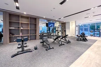a gym with several treadmills and exercise bikes at Skyline View, Stay High Rise Luxury next to Burj in Dubai