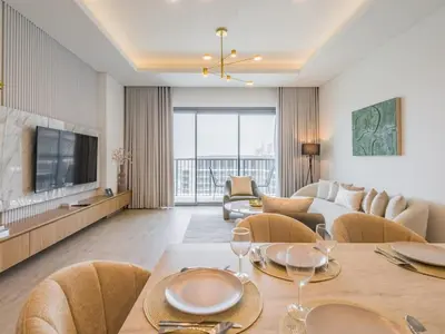 a living room with a dining table and a couch at TRPS - Central Park, City Walk, Al Wasl - 2BR Modern Residence - Elegantly Furnished to High Standards in Dubai