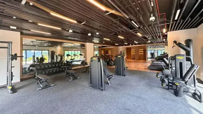 a gym with several treadmills and cardio machines at TRPS - Central Park, City Walk, Al Wasl - 2BR Modern Residence - Elegantly Furnished to High Standards in Dubai