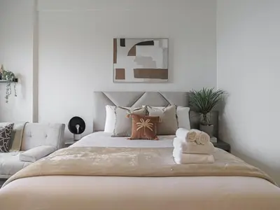 a bedroom with a large bed with towels on it at Welhome - Chic Studio with Balcony & City Views in Dubai in Dubai