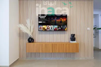 a lobby with a counter and a poster on the wall at Luxury 1 Br Marina Near Tram Ain Sea View Balcony in Dubai