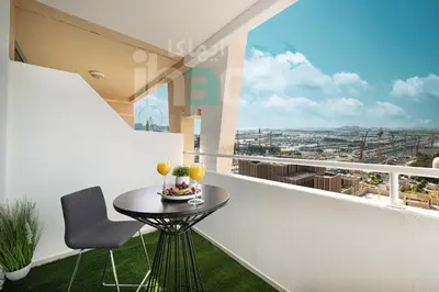 a small table on a balcony with drinks on it at Luxury 1 Br Marina Near Tram Ain Sea View Balcony in Dubai