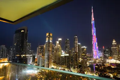 a view of a city skyline at night at Stunning 4BR Apartment with Full Burj Khalifa and Fountain View in Dubai