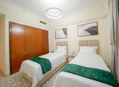 two beds sitting next to each other in a room at Stunning 4BR Apartment with Full Burj Khalifa and Fountain View in Dubai