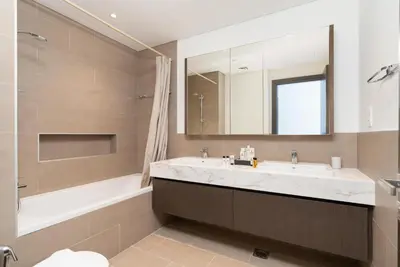 a bathroom with a sink and a tub and a mirror at Creek Side 18 I Harbor Views I in Dubai