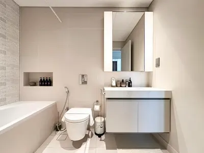 a bathroom with a toilet and a sink and a tub at Trophy-Sunset Coral Retreat Beachfront Living in Dubai