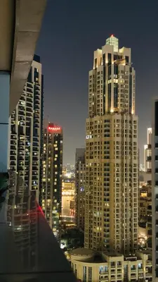 a view of a city at night with tall buildings at Downtown Apt - Near Burj Khalifa - Free Parking in Dubai