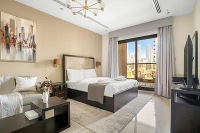 a hotel room with a bed and a couch at Stylish Downtown Studio in Dubai