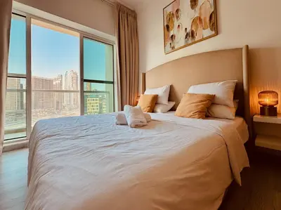 a bedroom with a large bed with a large window at Canal View Comfort Business Bay in Dubai
