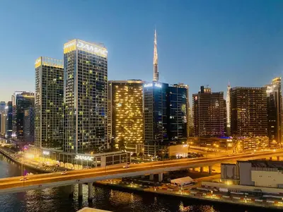 a view of a city with a bridge and buildings at Canal View Comfort Business Bay in Dubai