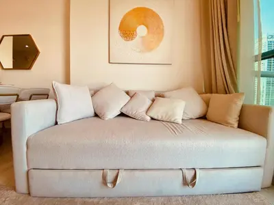 a couch with pillows on it in a living room at Canal View Comfort Business Bay in Dubai