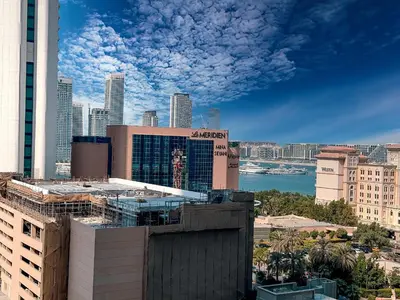 a view of a city with buildings and the ocean at DreamShoma-Sea View 2BR Pool Gym in Dubai