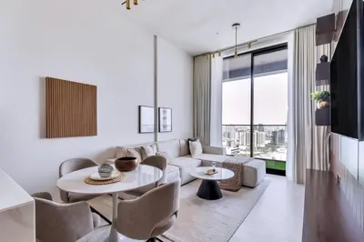 a living room with a couch and a table and chairs at GuestReady - Charming haven in JVC in Dubai