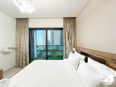 a bedroom with a large bed and a large window at Spacious 2B in Sobha Creek Vistas ,Dubai in Dubai