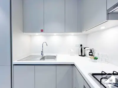a white kitchen with white cabinets and a sink at Spacious 2B in Sobha Creek Vistas ,Dubai in Dubai