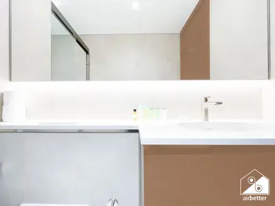 a white bathroom with a sink and a mirror at Spacious 2B in Sobha Creek Vistas ,Dubai in Dubai