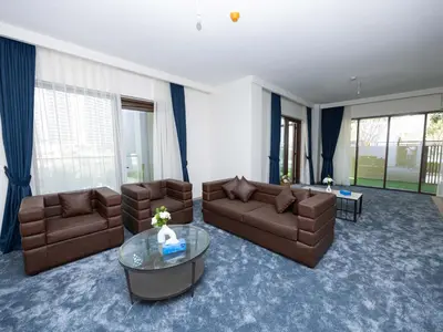 a living room with two couches and a glass table at Beach Access, Burj Khalifa View, Family Friendly in Dubai
