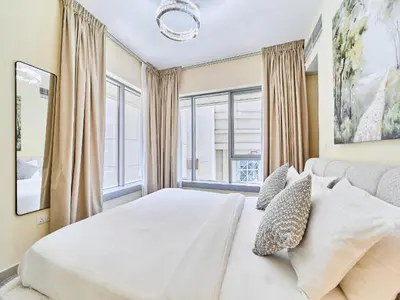 a bedroom with a white bed and a large window at Golden Homes 29 blvd tower Urban nest 1BR Near Dubai mall & burj khalifa downtown dubai in Dubai