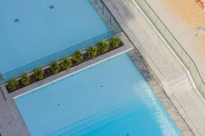 an overhead view of a swimming pool next to a building at Daniels Studio with Canal View at Marasi Drive in Dubai