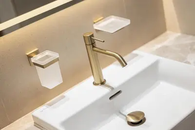 a bathroom sink with a gold faucet at Daniels Studio with Canal View at Marasi Drive in Dubai