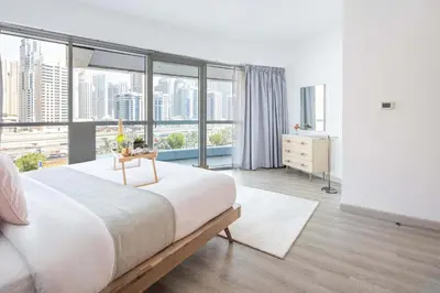 a bedroom with a large bed and a large window at Frank Porter - Saba 3 in Dubai