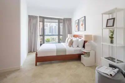 a bedroom with a bed and a large window at Frank Porter - Saba 3 in Dubai