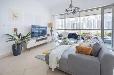 a large living room with a couch and a tv at Frank Porter - Saba 3 in Dubai