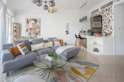 a living room with a gray couch and a table at Frank Porter - Saba 3 in Dubai