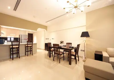 a dining room and living room with a table and chairs at Luxury 2BR Apartment in Downtown Dubai Elite Stay in Dubai