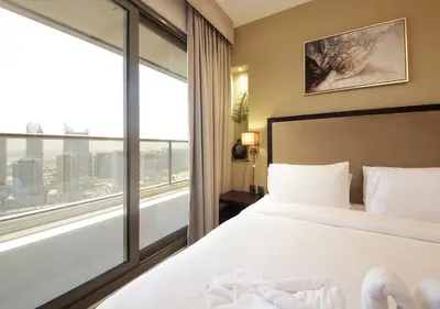 a bedroom with a white bed and a large window at Luxury 2BR Apartment in Downtown Dubai Elite Stay in Dubai