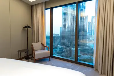 a hotel room with a bed and a large window at ADDRESS Residences Dubai Opera at Downtown in Dubai