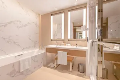 a bathroom with a tub and a sink and a mirror at ADDRESS Residences Dubai Opera at Downtown in Dubai