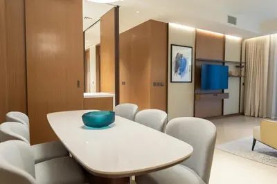 a dining room with a white table and chairs at ADDRESS Residences Dubai Opera at Downtown in Dubai