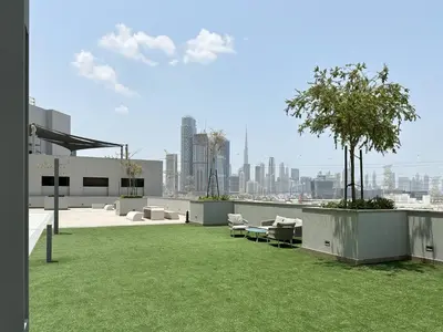 a view of a building with a green lawn at Trophy-Live in Style Artistic Flair Unit in Dubai