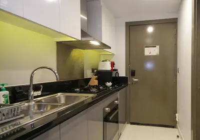 a kitchen with a sink and a stove at Dubai Dreams Pool & Canal View at Prive in Dubai