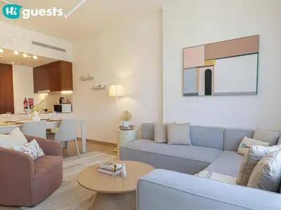 a living room with a couch and a table at HiGuests - La Rive Living Classy 2BR with Balcony in Dubai