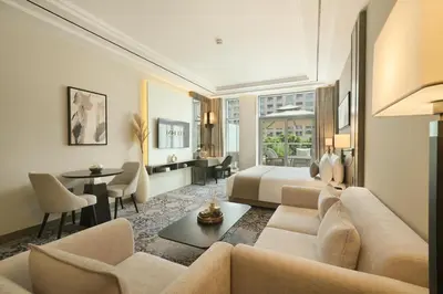 a living room with a couch and a bed and a table at Mileo Hotel The Palm in Dubai