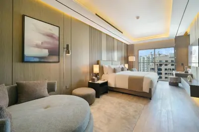 a hotel room with a bed and a couch at Mileo Hotel The Palm in Dubai