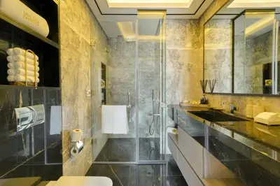 a bathroom with a shower and a sink at Mileo Hotel The Palm in Dubai