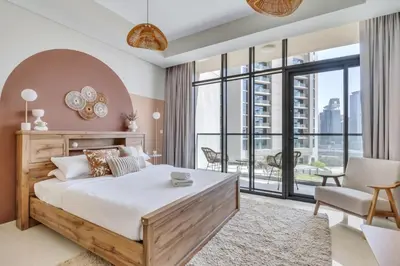 a bedroom with a large bed and a large window at GuestReady - Luxury Oasis in Business Bay in Dubai