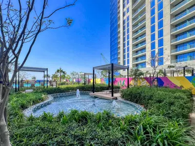 a fountain in a park in front of a tall building at GuestReady - Luxury Oasis in Business Bay in Dubai
