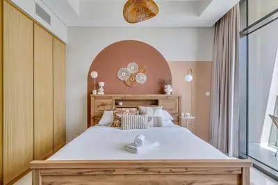 a bedroom with a large bed and a large window at GuestReady - Luxury Oasis in Business Bay in Dubai