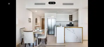a kitchen and dining room with a table and chairs at Luxurious Downtown Views 2 bedrooms holiday home in Dubai