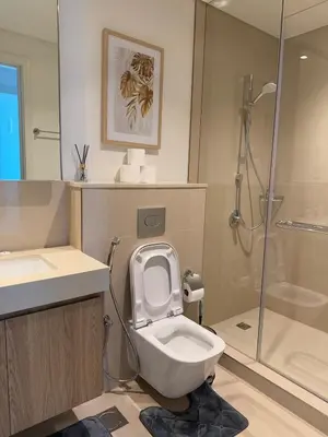 a bathroom with a toilet and a sink and a shower at Luxurious Downtown Views 2 bedrooms holiday home in Dubai