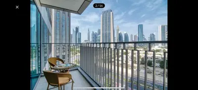a balcony with two chairs and a view of a city at Luxurious Downtown Views 2 bedrooms holiday home in Dubai