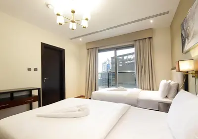 a hotel room with two beds and a window at Downtown Dubai Stay in 2BR Chic Elite Apartment in Dubai
